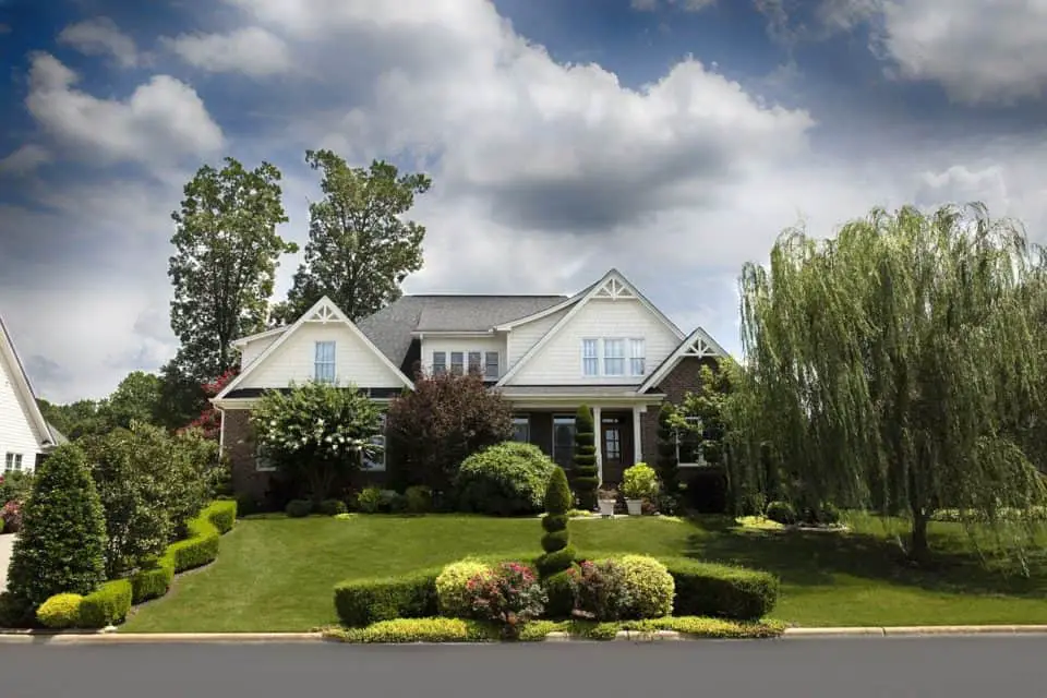 A house with lots of shrubs on the article Top 7 Shrubs to Plant in Front of Your House