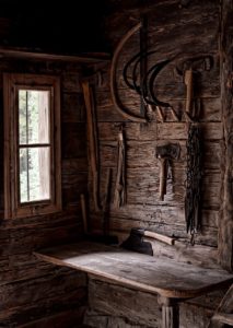 Lots of tools hung up in a wooden shed