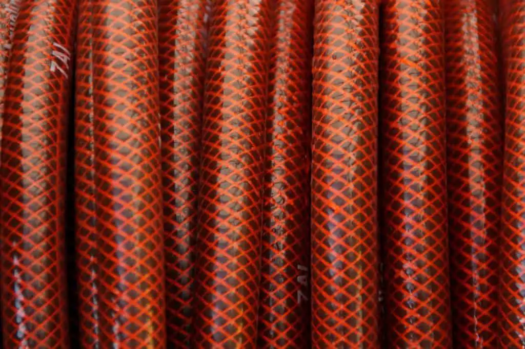 A red garden hose on the article What Is The Longest Garden Hose Available?